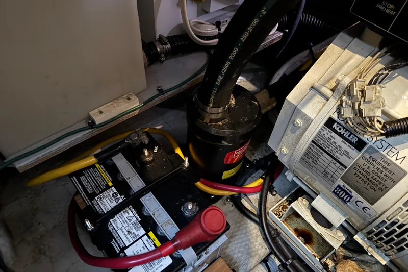 Slide: The Image of Engine compartment of 2002 Silverton 352 Motor Yacht with battery and Kohler power system. - 103