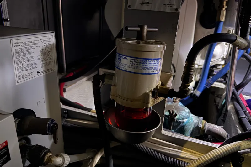 Slide: The Image of 2002 Silverton 352 Motor Yacht engine room with diesel fuel filter and water separator. - 105