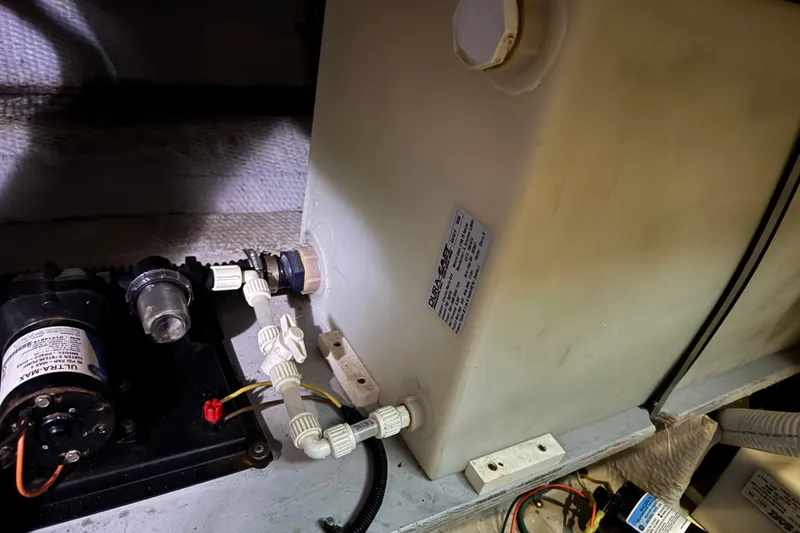 Slide: The Image of 2002 Silverton 352 Motor Yacht engine room with water tank and pump system. - 108