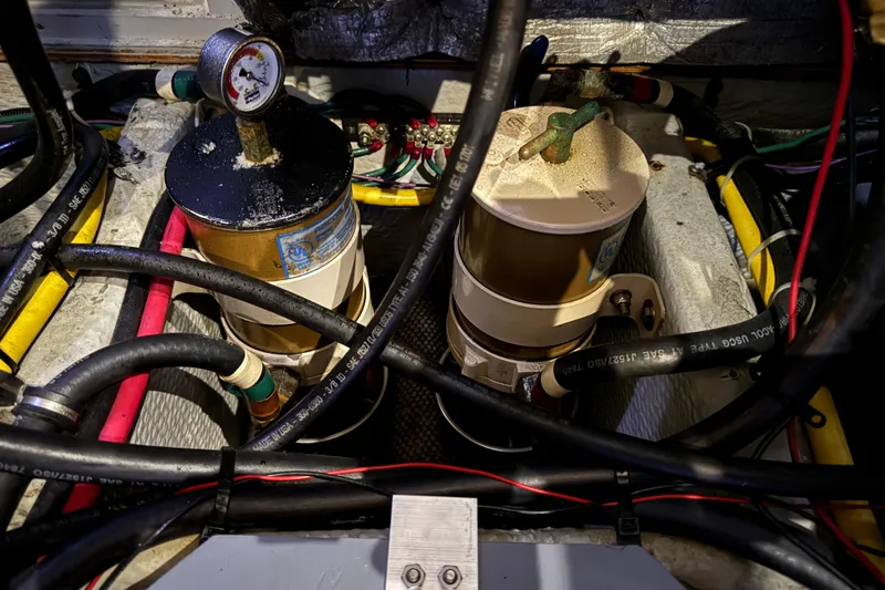 Slide: The Image of Engine compartment of a 2002 Silverton 352 Motor Yacht with fuel filters and hoses. - 113