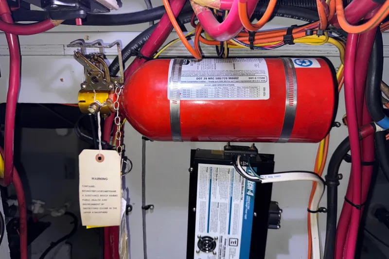 Slide: The Image of Fire suppression system in 2002 Silverton 352 Motor Yacht engine room with wiring and warning tag. - 117