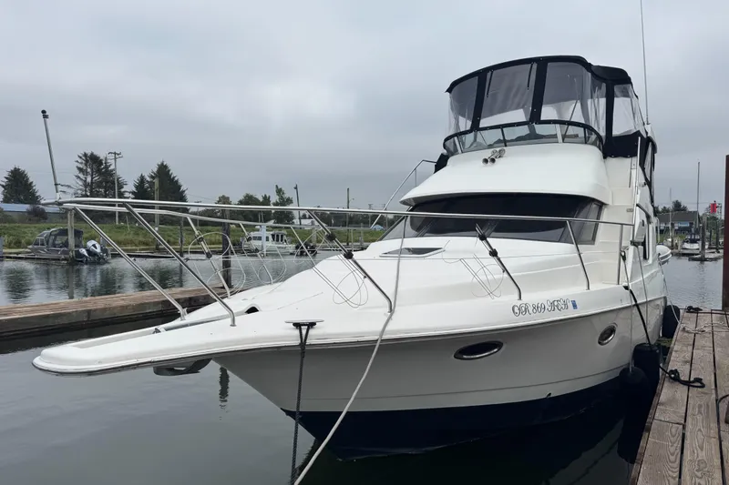 Slide: The Image of 2002 Silverton 352 Motor Yacht docked at marina, side view. - 2