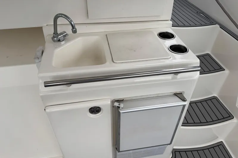Slide: The Image of 2002 Silverton 352 Motor Yacht kitchenette with sink, faucet, and storage. - 21
