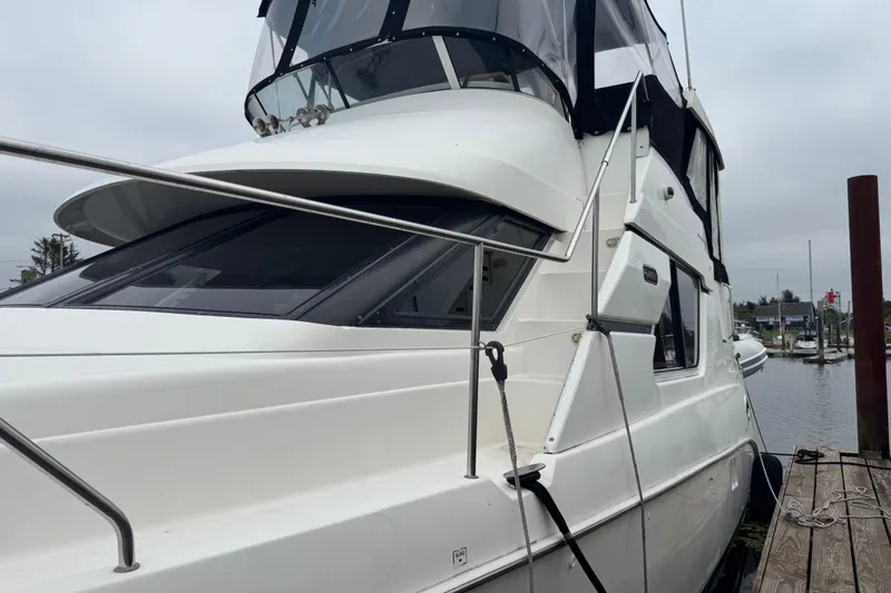 Slide: The Image of 2002 Silverton 352 Motor Yacht docked at marina, side view. - 3