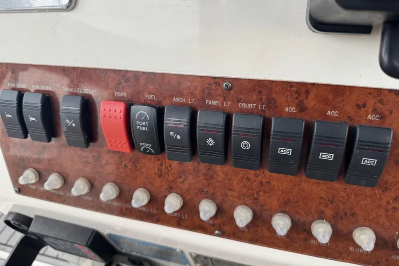 Slide: The Image of Control panel of a 2002 Silverton 352 Motor Yacht with various switches and buttons. - 30