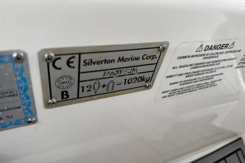 Slide: The Image of Plaque on 2002 Silverton 352 Motor Yacht showing weight capacity and safety warnings. - 33