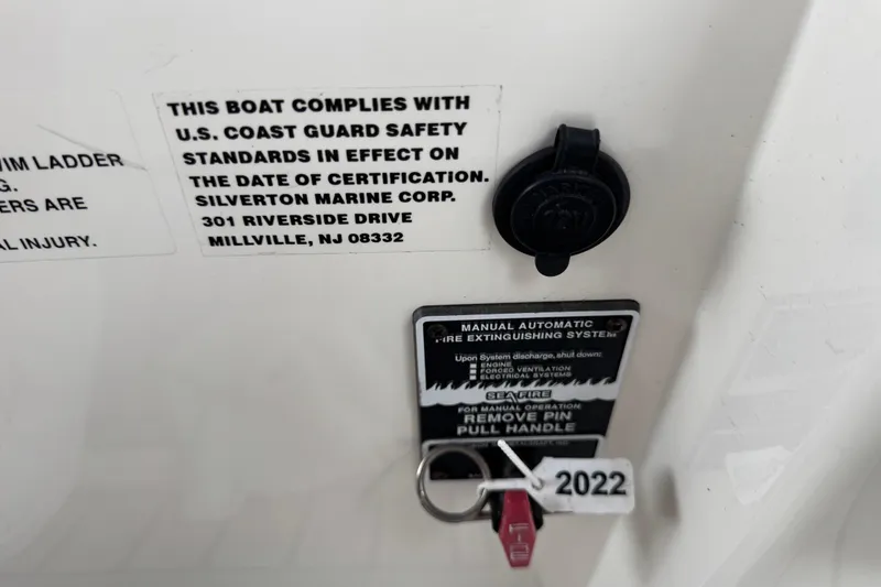 Slide: The Image of 2002 Silverton 352 Motor Yacht compliance and fire safety labels on white surface. - 34