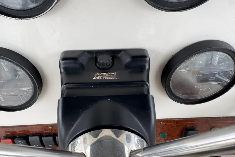 Slide: The Image of Control panel of a 2002 Silverton 352 Motor Yacht with gauges and switches. - 38