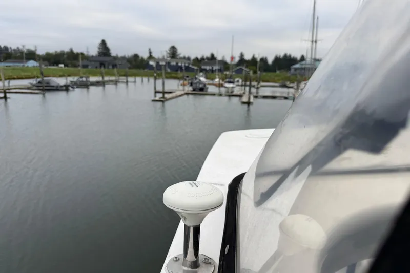 Slide: The Image of 2002 Silverton 352 Motor Yacht docked at a marina, calm water, overcast sky. - 40
