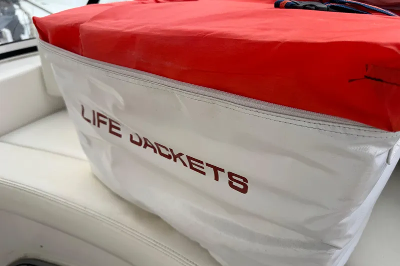 Slide: The Image of Life jackets stored on a 2002 Silverton 352 Motor Yacht, red and white bag. - 49