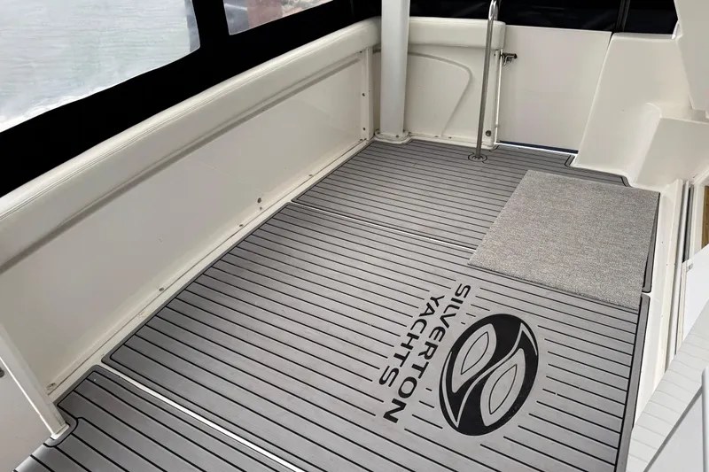 Slide: The Image of 2002 Silverton 352 Motor Yacht deck with branded flooring and sleek design. - 50