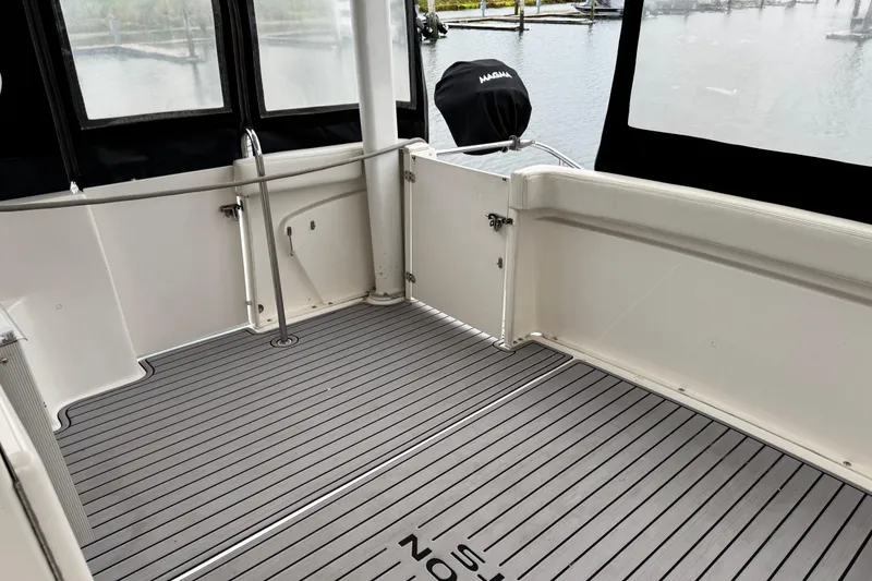 Slide: The Image of 2002 Silverton 352 Motor Yacht deck with railing and water view. - 53