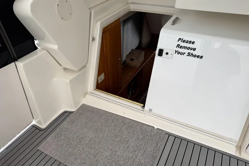Slide: The Image of 2002 Silverton 352 Motor Yacht entrance with "Please Remove Your Shoes" sign. - 54