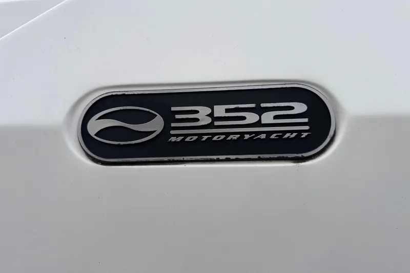 Slide: The Image of 2002 Silverton 352 Motor Yacht docked, featuring sleek design and spacious deck area. - 6