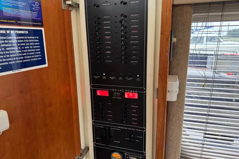 Slide: The Image of Electrical control panel inside a 2002 Silverton 352 Motor Yacht, featuring various switches and indicators. - 61