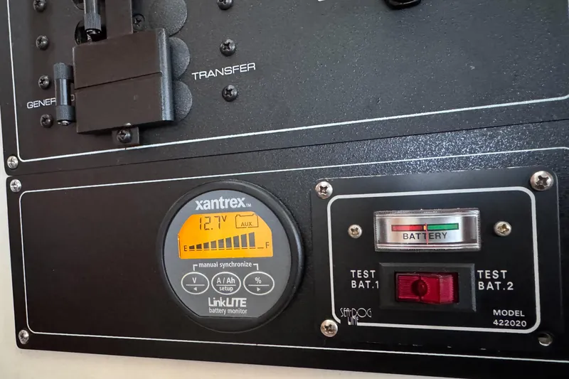 Slide: The Image of Control panel of a 2002 Silverton 352 Motor Yacht with battery monitor and switches. - 62