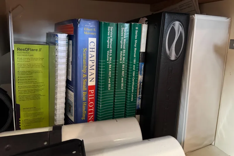 Slide: The Image of Books and manuals on seamanship and boat handling, including Silverton 352 Motor Yacht materials. - 63