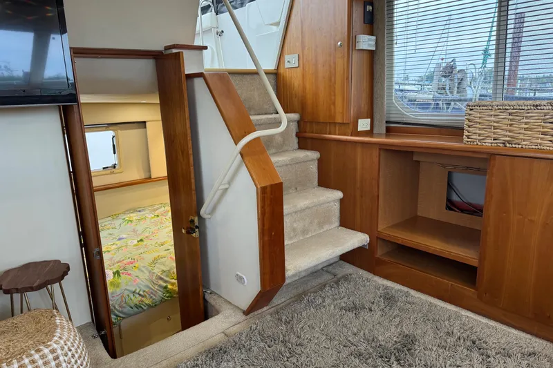 Slide: The Image of Interior of 2002 Silverton 352 Motor Yacht with stairs, bedroom, and window view. - 65