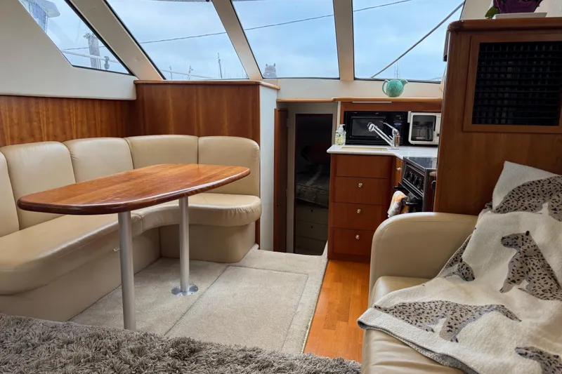 Slide: The Image of Interior of 2002 Silverton 352 Motor Yacht with cozy seating and kitchenette. - 67