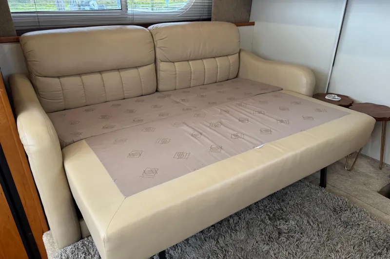 Slide: The Image of Beige leather sofa bed in 2002 Silverton 352 Motor Yacht interior. - 69