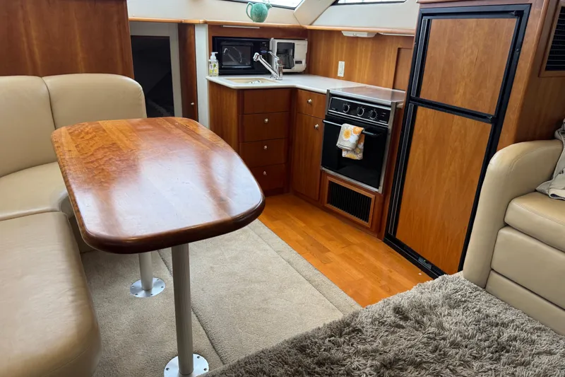Slide: The Image of Interior of 2002 Silverton 352 Motor Yacht with kitchen and dining area. - 71