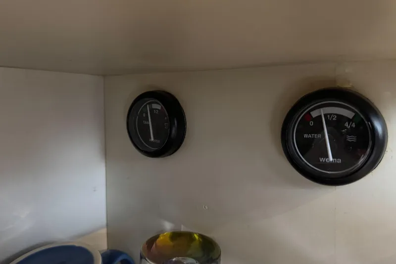 Slide: The Image of Gauges on 2002 Silverton 352 Motor Yacht dashboard, displaying tank and water levels. - 76