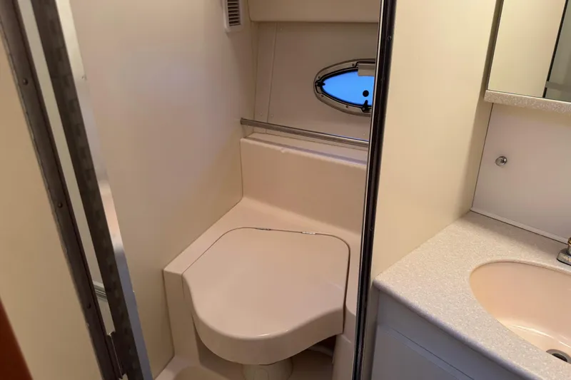 Slide: The Image of 2002 Silverton 352 Motor Yacht bathroom with compact toilet and sink. - 77