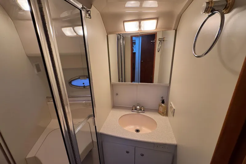 Slide: The Image of Bathroom interior of 2002 Silverton 352 Motor Yacht with sink and shower. - 81