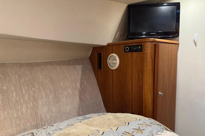 Slide: The Image of 2002 Silverton 352 Motor Yacht interior with TV and wooden cabinet. - 87