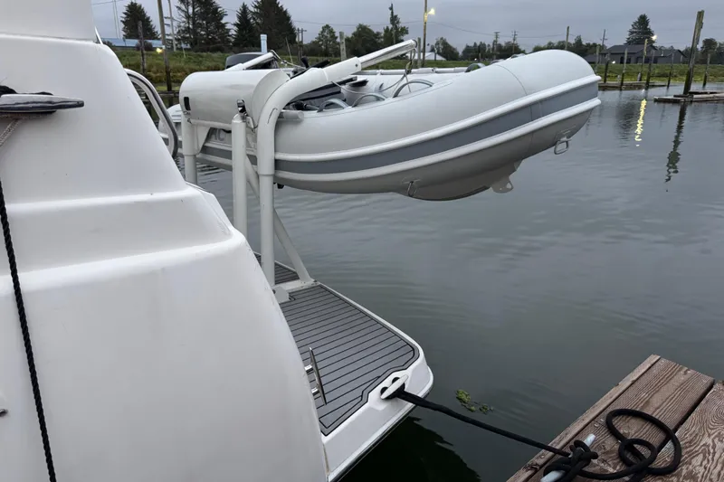 Slide: The Image of 2002 Silverton 352 Motor Yacht docked at marina, clear sky background. - 9