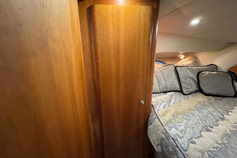 Slide: The Image of Interior of 2002 Silverton 352 Motor Yacht with cozy bed and wooden cabinetry. - 90