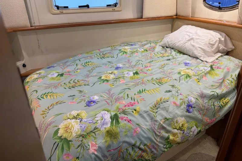 Slide: The Image of Cozy bedroom in 2002 Silverton 352 Motor Yacht with floral bedding and porthole window. - 91