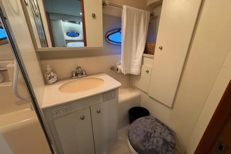 Slide: The Image of 2002 Silverton 352 Motor Yacht bathroom with sink, mirror, and towel rack. - 94