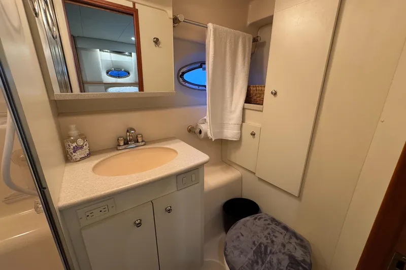 Slide: The Image of 2002 Silverton 352 Motor Yacht bathroom with sink, mirror, and towel. - 95