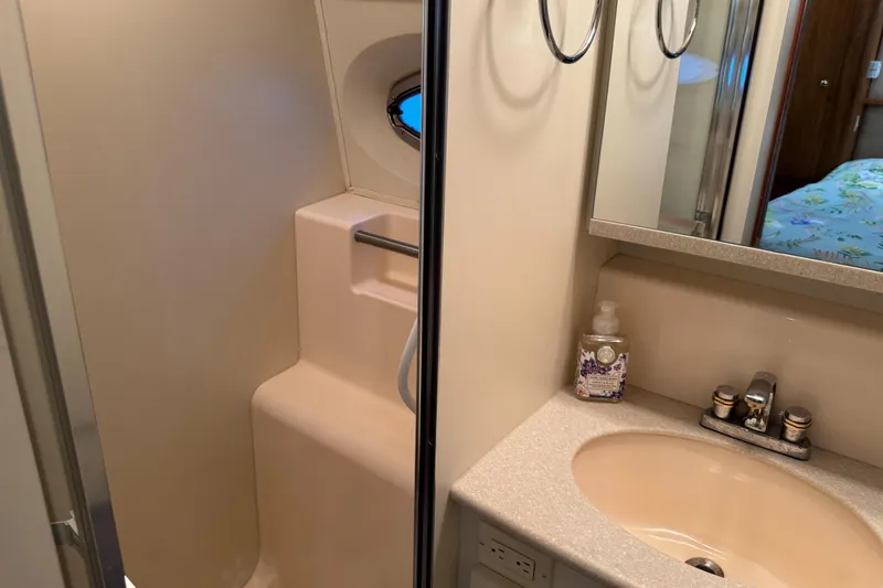 Slide: The Image of Bathroom interior of 2002 Silverton 352 Motor Yacht with sink and shower area. - 97