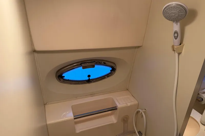 Slide: The Image of 2002 Silverton 352 Motor Yacht bathroom with showerhead and porthole window. - 98