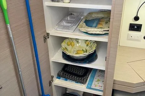 Slide: The Image of Cabinet with dishes and cleaning supplies on a 2021 Fountaine Pajot Isla 40 yacht. - 10