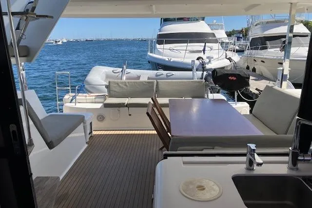 Slide: The Image of 2021 Fountaine Pajot Isla 40 catamaran with spacious deck, docked at marina. - 18