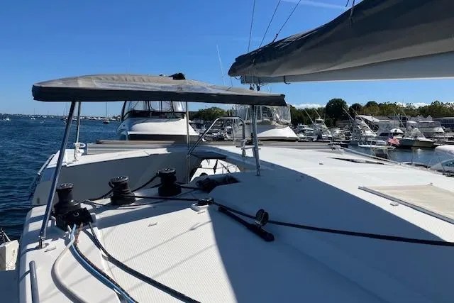 Slide: The Image of 2021 Fountaine Pajot Isla 40 catamaran docked at a marina under clear blue skies. - 24