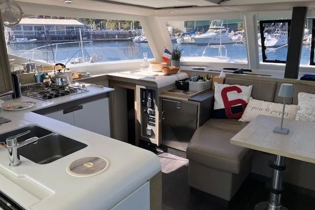 Slide: The Image of Interior of 2021 Fountaine Pajot Isla 40 catamaran with modern kitchen and seating area. - 28