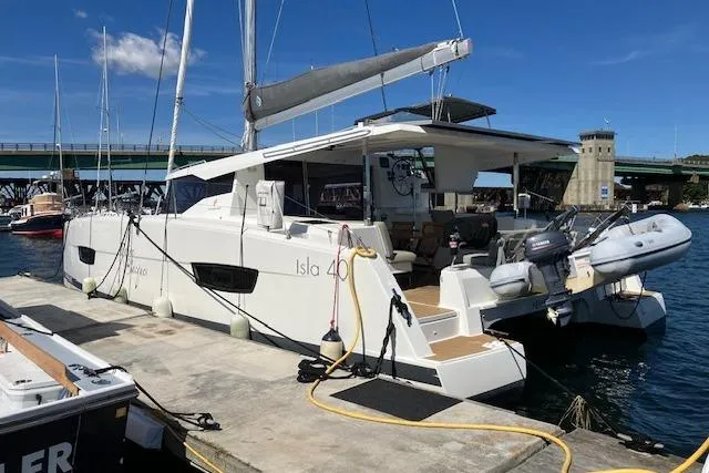 Slide: The Image of 2021 Fountaine Pajot Isla 40 catamaran docked at marina under clear blue sky. - 32