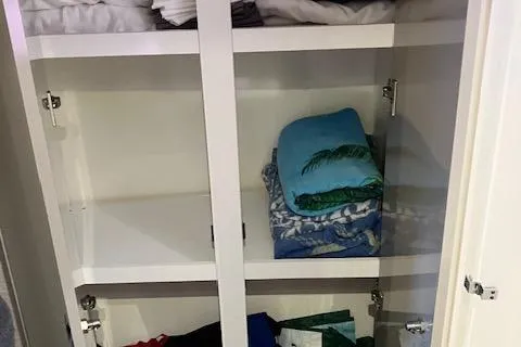 Slide: The Image of Cabinet with neatly folded clothes inside a Fountaine Pajot Isla 40, 2021 model. - 6