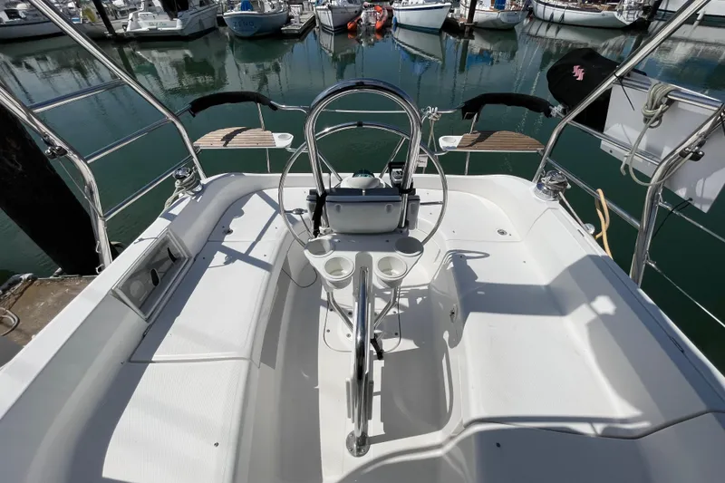 Slide: The Image of Cockpit of a 2004 Hunter 33-2 sailboat docked at a marina. - 13