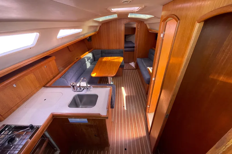 Slide: The Image of Interior of 2004 Hunter 33-2 sailboat with wood finish and compact kitchen. - 15