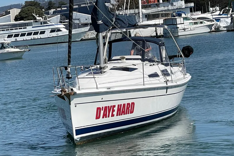 Slide: The Image of 2004 Hunter 33-2 sailboat named "D'AYE HARD" in a marina setting. - 4