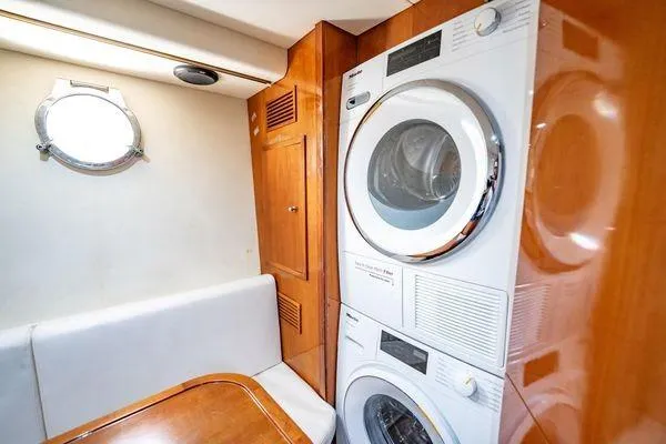 Slide: The Image of Laundry area inside 2003 Azimut 80 Carat yacht with stacked washer and dryer. - 13