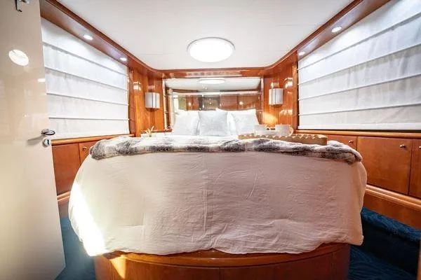 Slide: The Image of Luxurious bedroom interior of 2003 Azimut 80 Carat yacht with elegant wood paneling. - 21