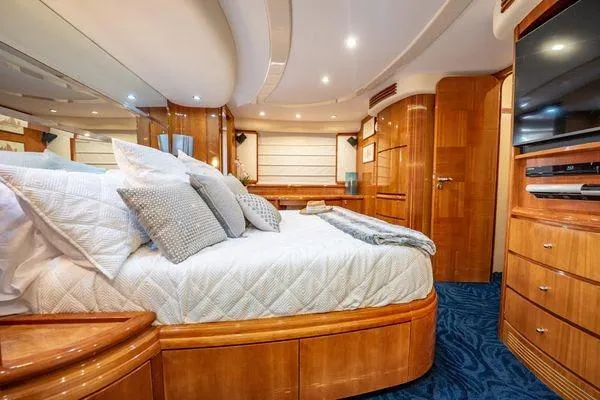 Slide: The Image of Luxurious bedroom interior of 2003 Azimut 80 Carat yacht with elegant wood finishes. - 28
