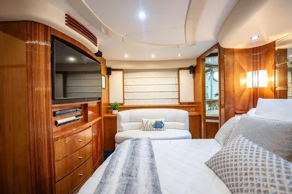 Slide: The Image of Luxurious interior of 2003 Azimut 80 Carat yacht with elegant wood finishes and cozy seating. - 31