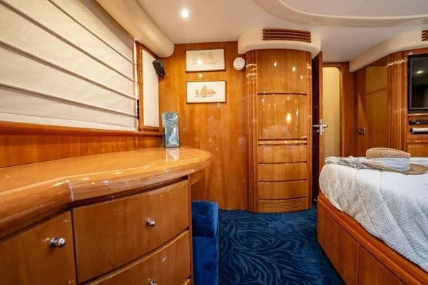 Slide: The Image of Luxurious interior of 2003 Azimut 80 Carat yacht with elegant wood finishes and plush bedding. - 32